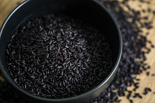 Heap of black rice in a bowl.