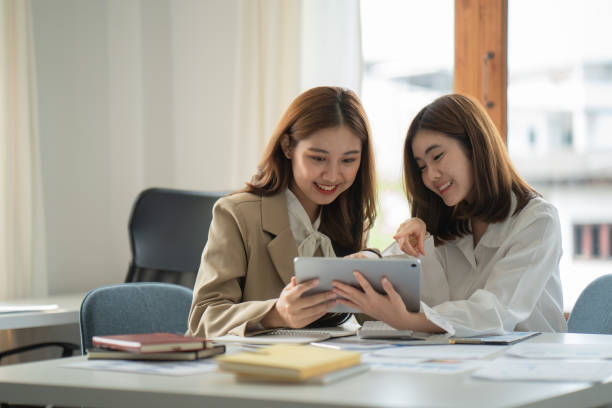 istock Two female assistant, businesswomen are working together on digital tablet computer. 1388780549