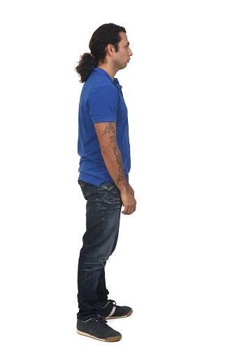 side view of a man with ponytail and tattoo on white background