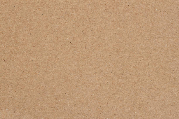 istock Brown recycled paper background, texture close-up. Recyclable material 1388783263