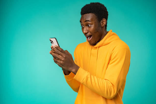 istock Afro american man using smartphone over isolated mint background 1388786151