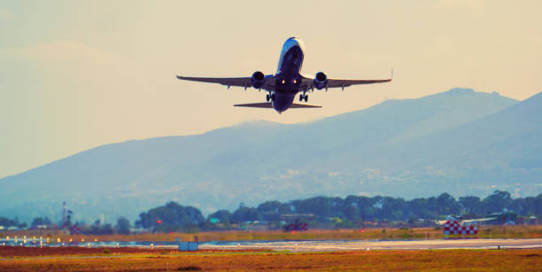 istock Airplane with moody sky 1388787203