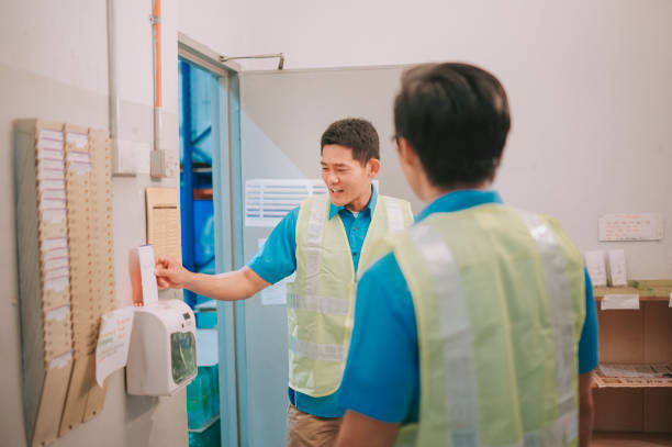 istock Asian Chinese blue collar worker checking in and talking in factory 1388790985