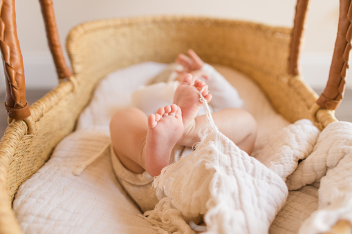 Close up of tiny newborn baby feet and toes