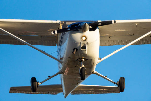 istock Small plane flying with sunset light in a clear sky before landing on Sabadell Airport. 1388791250