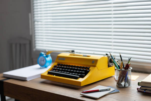 istock Vintage old typewriter on wooden desk table. Writer creative concept 1388793337