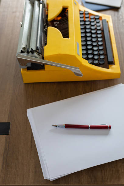 Vintage old typewriter at wooden desk table. Writer or screenwriter creative concept