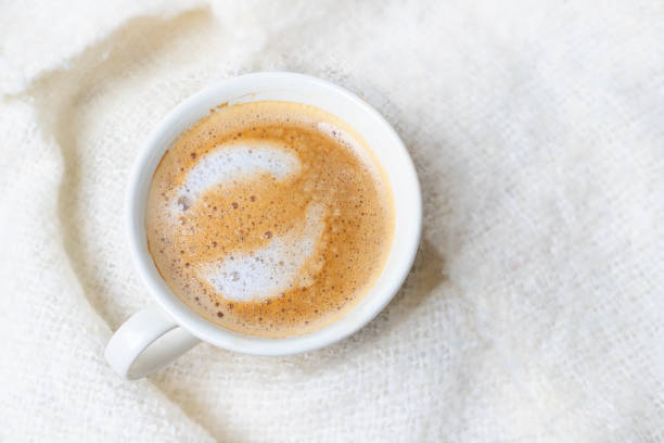 istock Cup of coffee in bed with blanket seen from above 1388795658