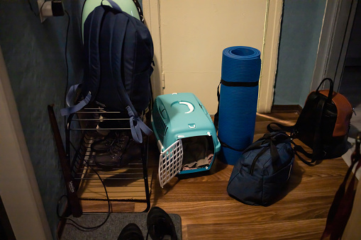 Karemat, bags and pet carrier are ready in the corridor  for going to the shelter during the war in Ukraine