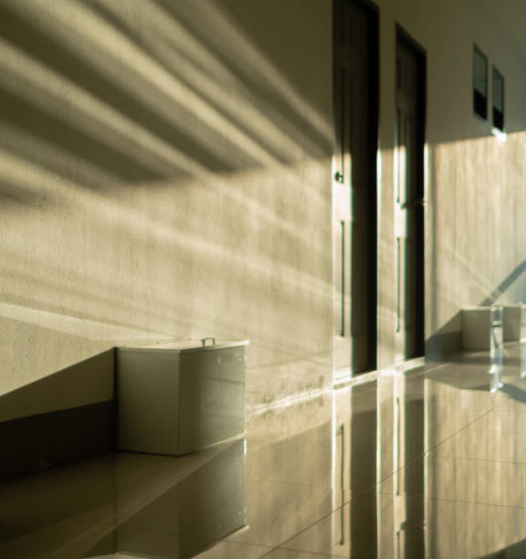 A blurry and unfocused picture of the corridor of the earth room, with warm light shining from the side of the reflection of the door and some box in front of the room. stock photo