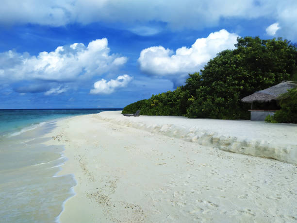 istock Maldives, the empty beach with small water cafe. A white sand, turquoise ocean and a blue sky. 1388797900