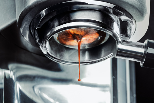 Coffee machine pouring out a cappacino