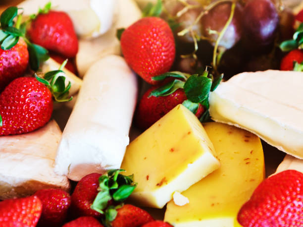 Close-up of a cheese and fruit platter at a breakfast buffet.