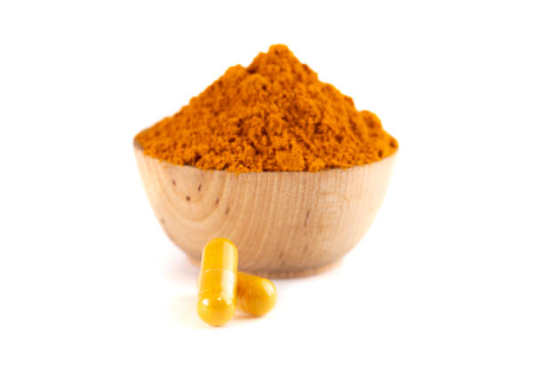 istock Ground Turmeric in Capsule form Isolated on a White Background 1388803218
