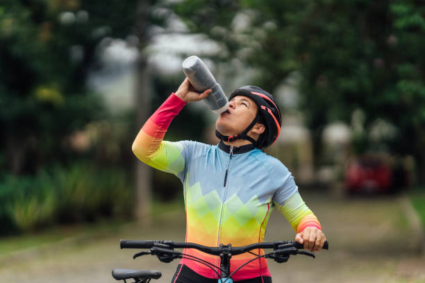 istock Cyclist woman drinking water 1388804092