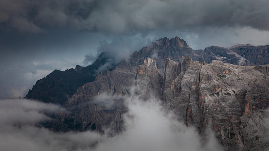 Mountain cliffs at Three Peaks and Paternkofel in the Dolomite Alps in South Tyrol during summer with clouds