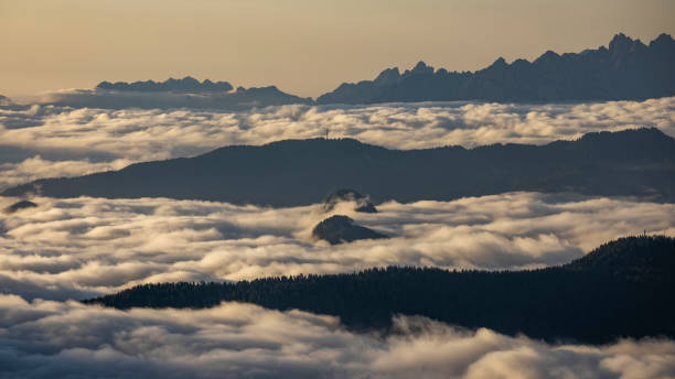 istock Inversion clouds between mountain layers during sunrise in the Dolomite Alps in South Tyrol, Italy 1388804388