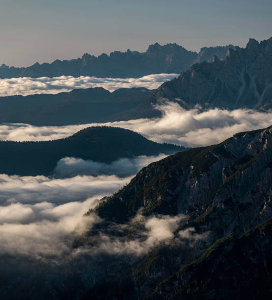 istock Inversion clouds between mountain layers during blue sky day in the Dolomite Alps in South Tyrol, Italy 1388804394