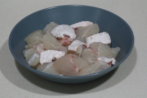 Sliced giant grouper Sliced giant grouper in a dish sliver of light on face stock pictures, royalty-free photos & images