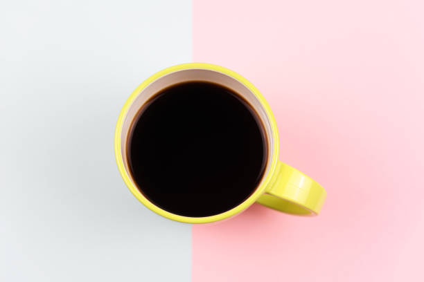istock Cup of coffee on colored background 1388807812