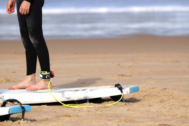 istock Young people surfing on the beach in summer, board leash 1388808667