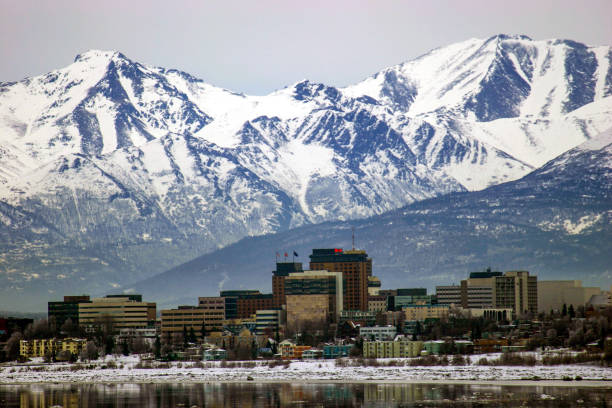 Downtown Anchorage, Alaska in winter Anchorage, Alaska skyline with the Chugach Mountains in the background anchorage alaska photos stock pictures, royalty-free photos & images