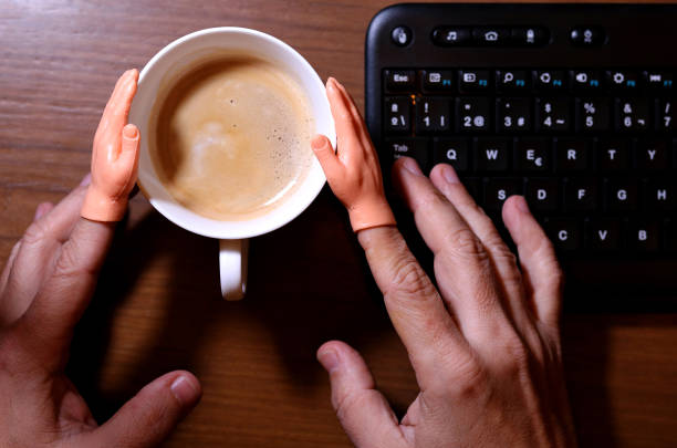 Joking little hands holding a coffee