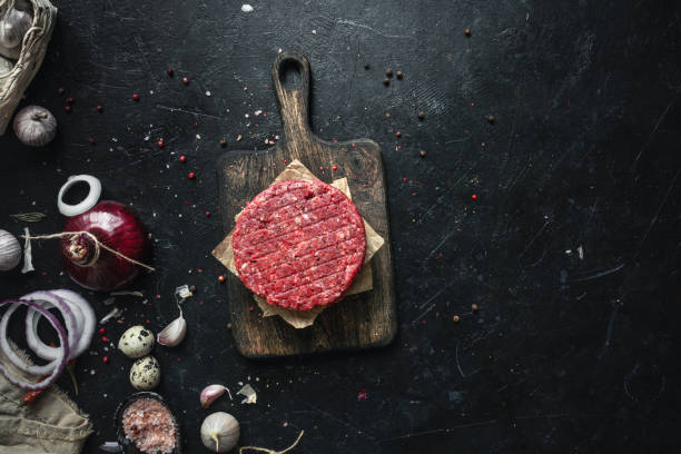 istock Raw burger patty and spices 1388814019