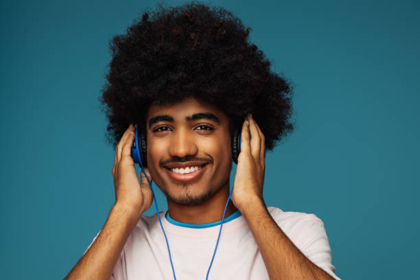 istock African american man with african hairstyle using phone 1388814143