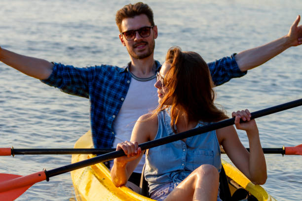 istock Couple kayaking on river with sunset on background 1388815099