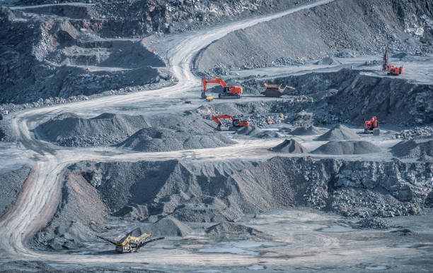 istock Excavators and drill rigs work in stone quarry 1388816473