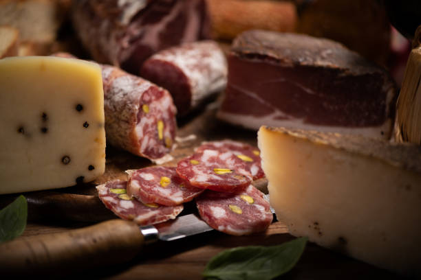 istock Cutting board with ham, salami, cheese, bread on a rustic wooden board 1388816691