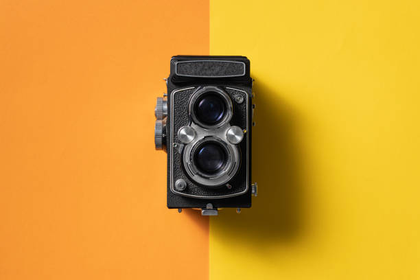 istock Retro analogue camera. Vintage old fashioned camera with lens. 1388817229