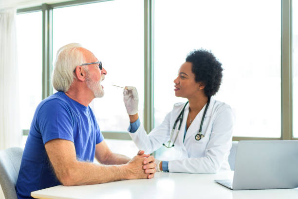 istock Female doctor examining man throat 1388818112