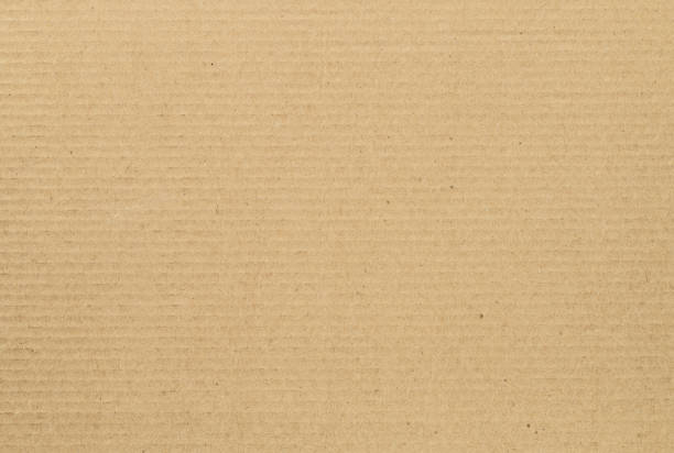 istock Sheet of brown cardboard paper. Textured backdrop 1388818304