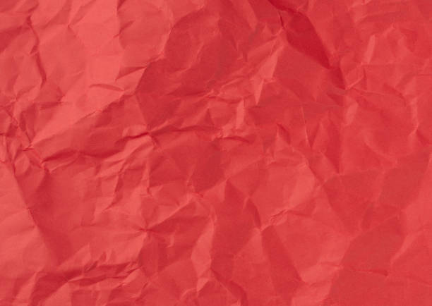 istock Wrinkled sheet of red, paper. Textured backdrop 1388818344