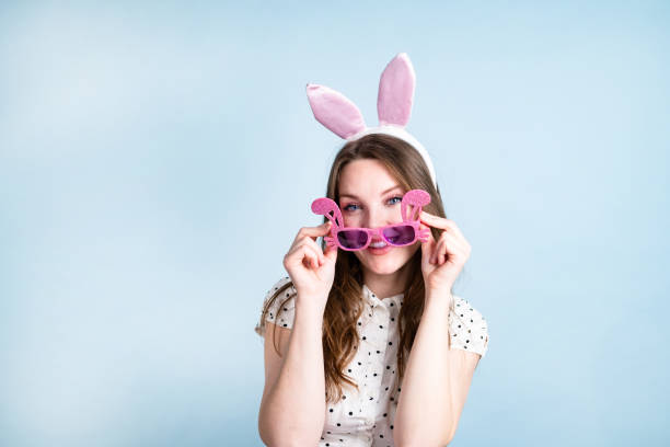 istock Woman having fun with her glitter sunglasses, looking at the camera. 1388819687