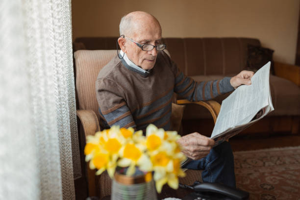 istock Senior man reading newspaper 1388819795
