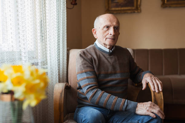 istock Cheerful mature man resting in armchair 1388819799