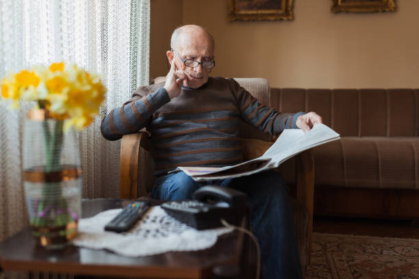 istock Intelligent senior man reading newspapers 1388819819