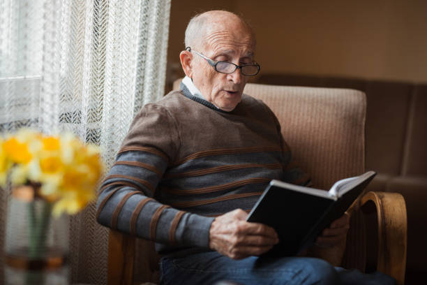 istock Senior man reading a book and acting surprised 1388819820