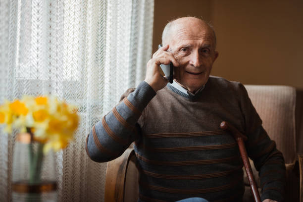 istock Cheerful elderly man having a phone conversation 1388819894