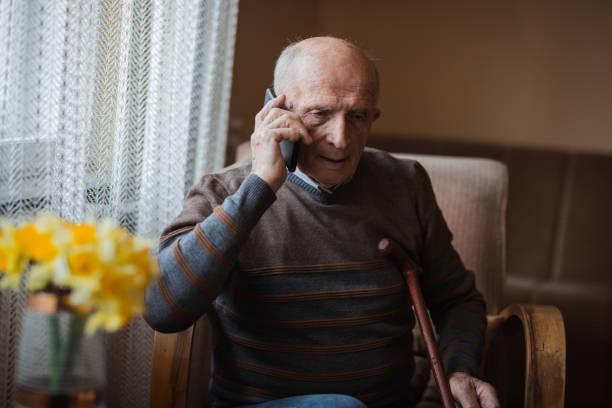 istock Older man sitting at home and having phone conversation 1388819910