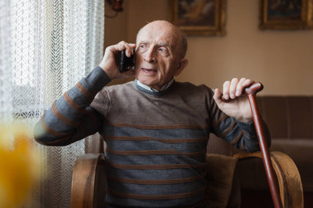 istock Serious mature man having mobile phone conversation 1388819932