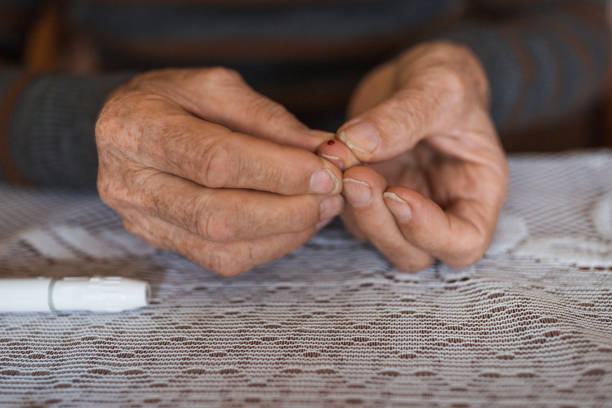 istock Wrinkled mature hand bleeding after insulin test 1388820084