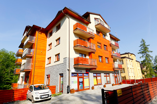 Zakopane, Poland - June 12, 2015: A modern apartment building, stylized to the traditional architecture of the neighboring buildings, located at Jagiellonska street, built early the 21st century.