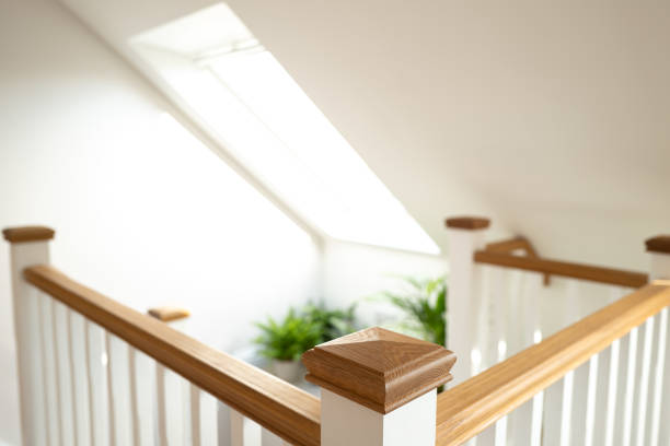 Shallow focus of a wooden post on the 2nd floor of a newly built loft conversion. Shallow focus of a wooden post on the 2nd floor of a newly built loft conversion. Showing the large skylight window. landing home interior stock pictures, royalty-free photos & images