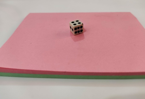 Close up of dice on Pink background