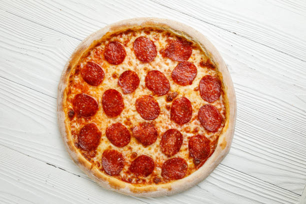 istock Italian pizza on a white wooden table 1388825270