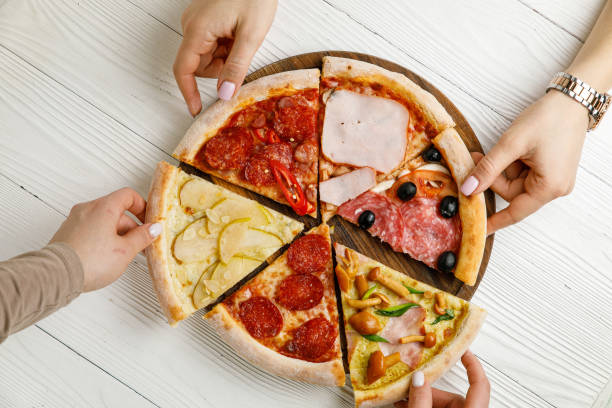 istock Assorted Italian pizza on a white wooden table. 1388825356